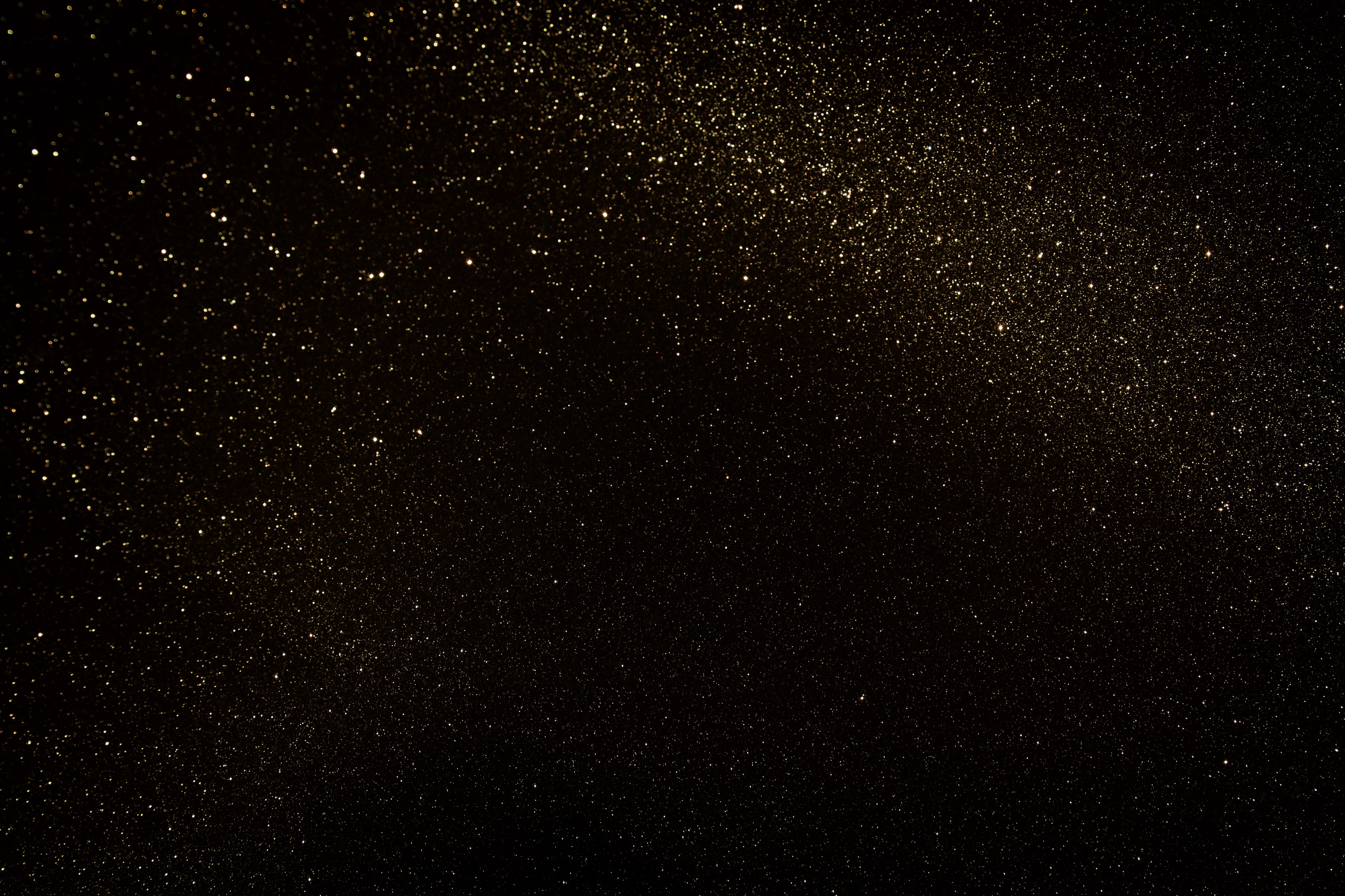 Gold and black glitter vintage lights background. defocused